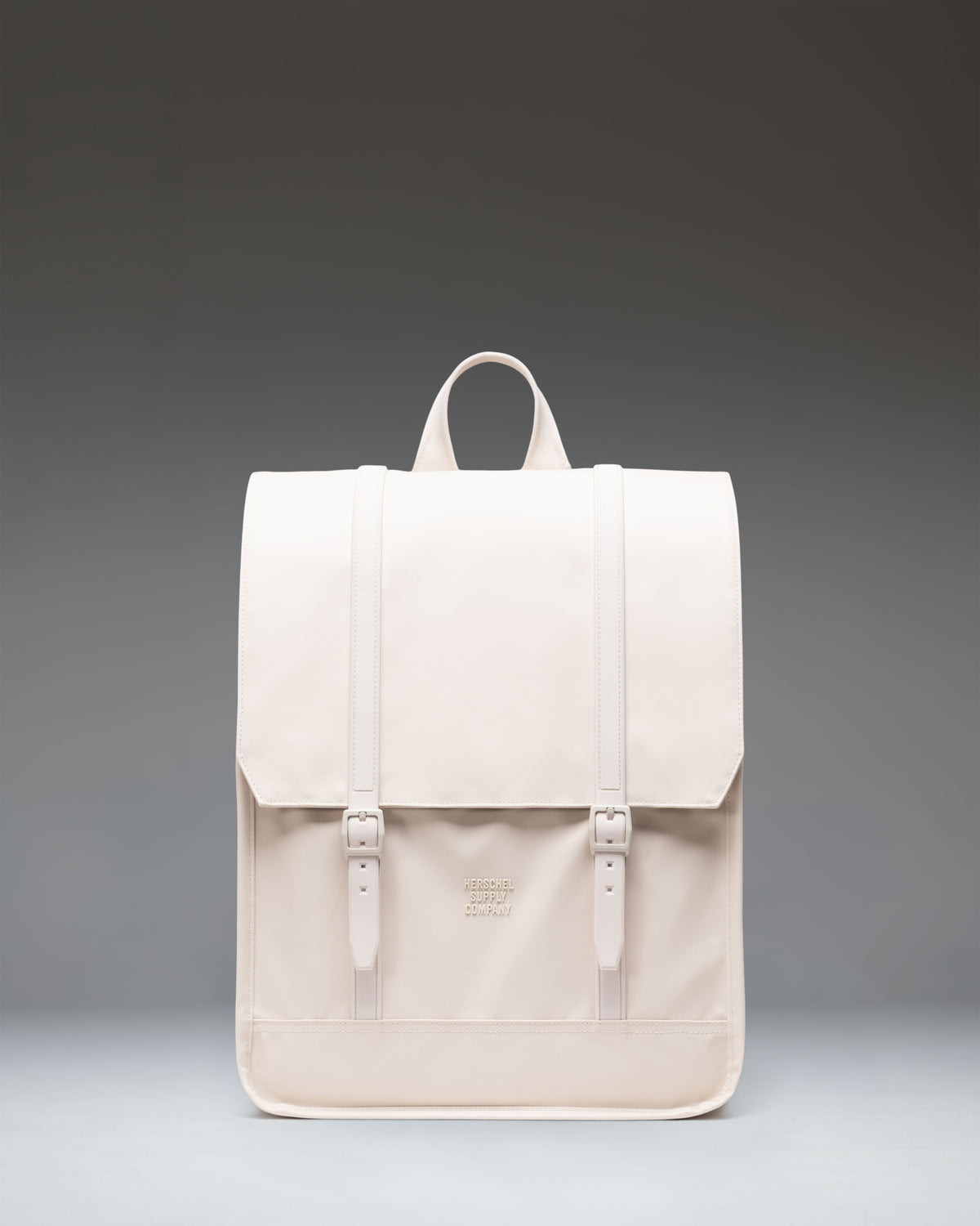 Herschel Survey Backpack in Moonbeam colorway, showcasing its minimalist square design with dual magnetic strap closures on a clean background.