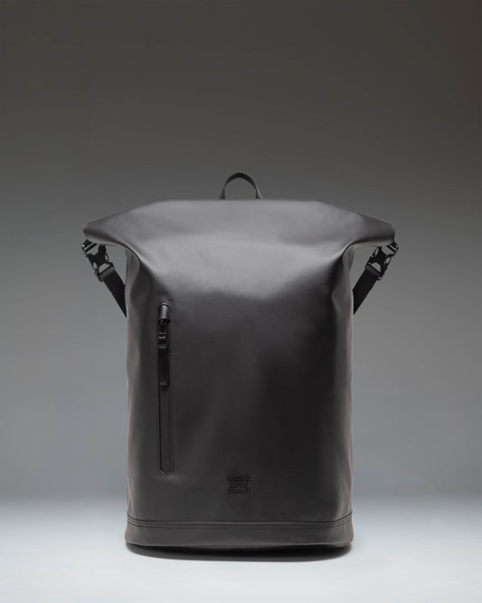 Herschel Supply Co Roll Top Backpack in black shown from an angled front view, highlighting its sleek design and roll-top closure.