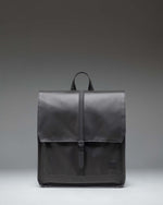 Herschel Supply Co City Backpack in black, showcasing a minimalist design with a single strap closure and a clean, modern aesthetic.