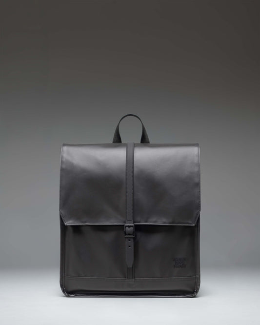 Herschel Supply Co City Backpack in black, showcasing a minimalist design with a single strap closure and a clean, modern aesthetic.