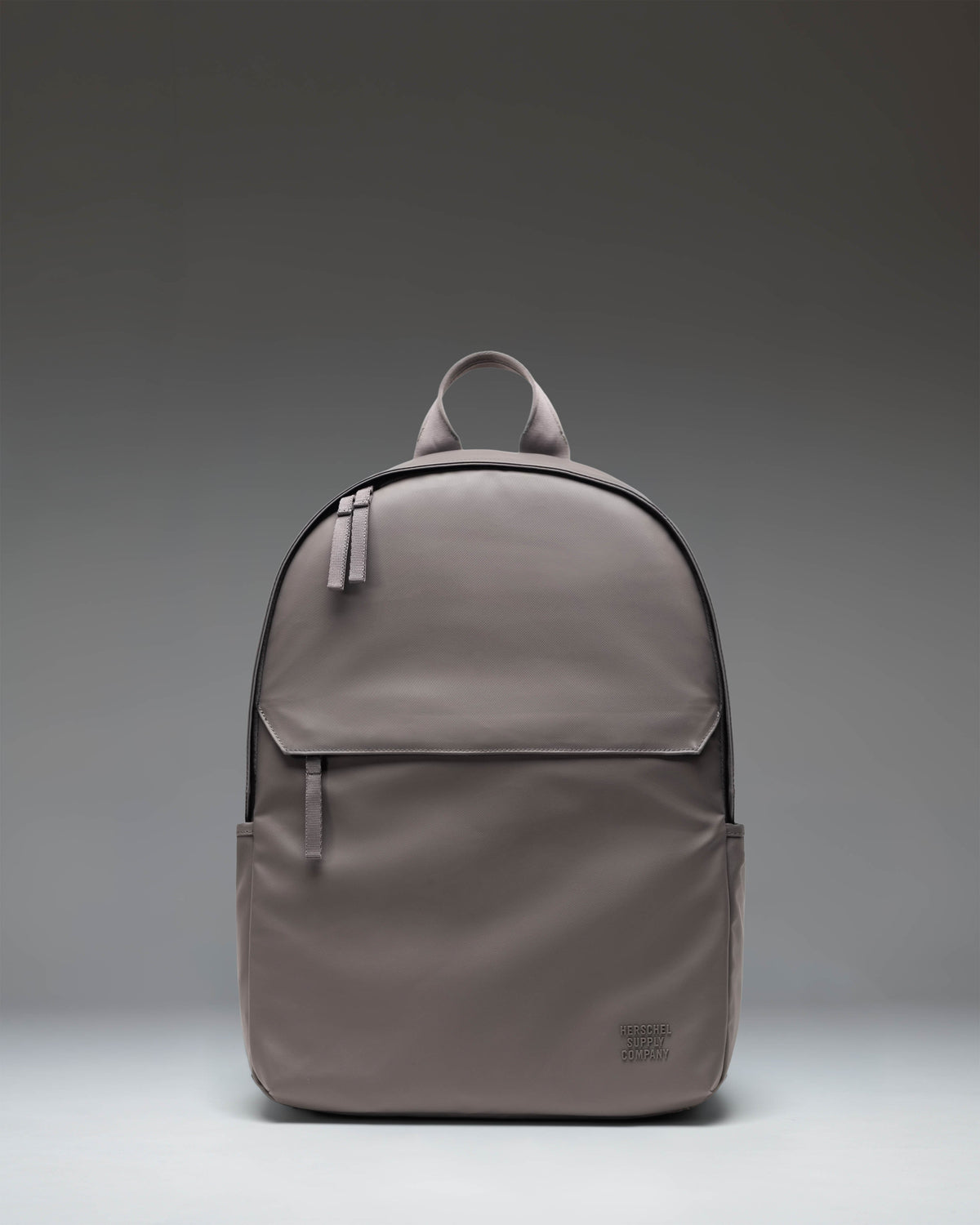 Herschel Supply Co. Dark Gull Gray Alberni Backpack shown from the front, highlighting its clean design and zippered front pocket.
