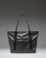 Herschel Supply Co. Alberni Tote in black, shown from a front perspective, highlighting its clean, durable design.