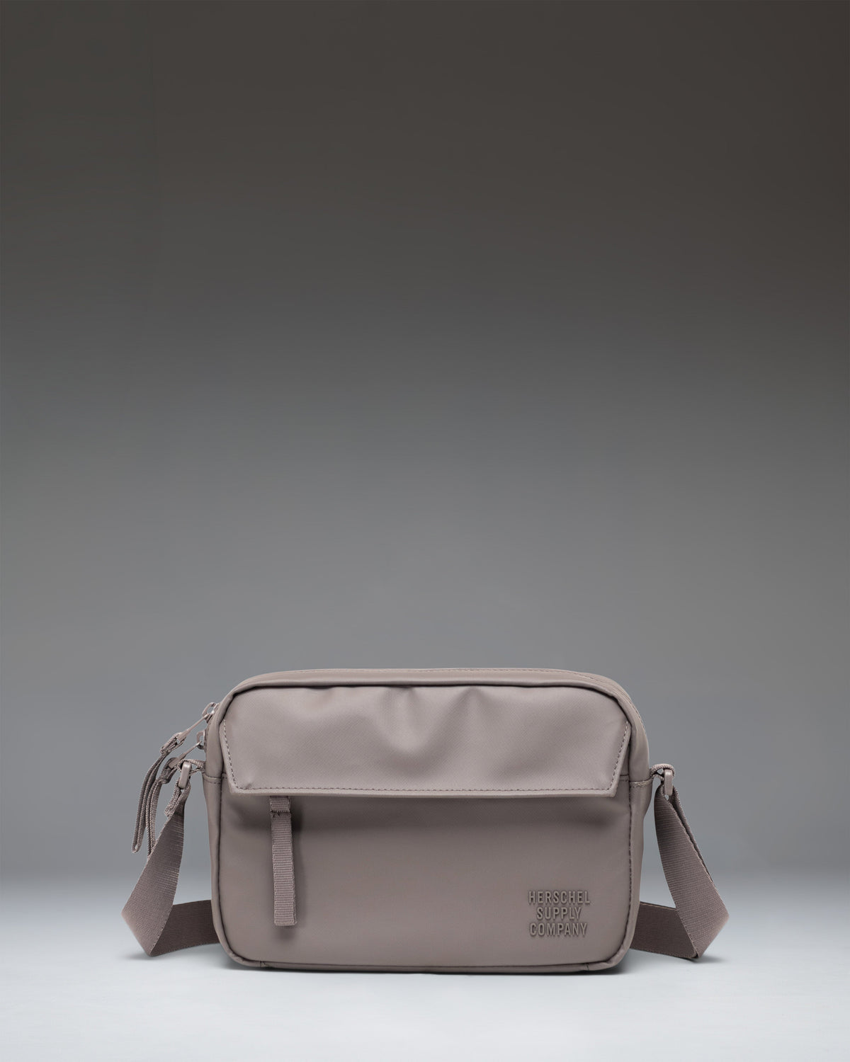 Front view of the Herschel Supply Co. Alberni Crossbody bag in Dark Gull Gray.