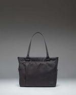 Black Herschel Supply Co. Kaslo Tote Tech bag shown from a front perspective, highlighting its clean, functional design.