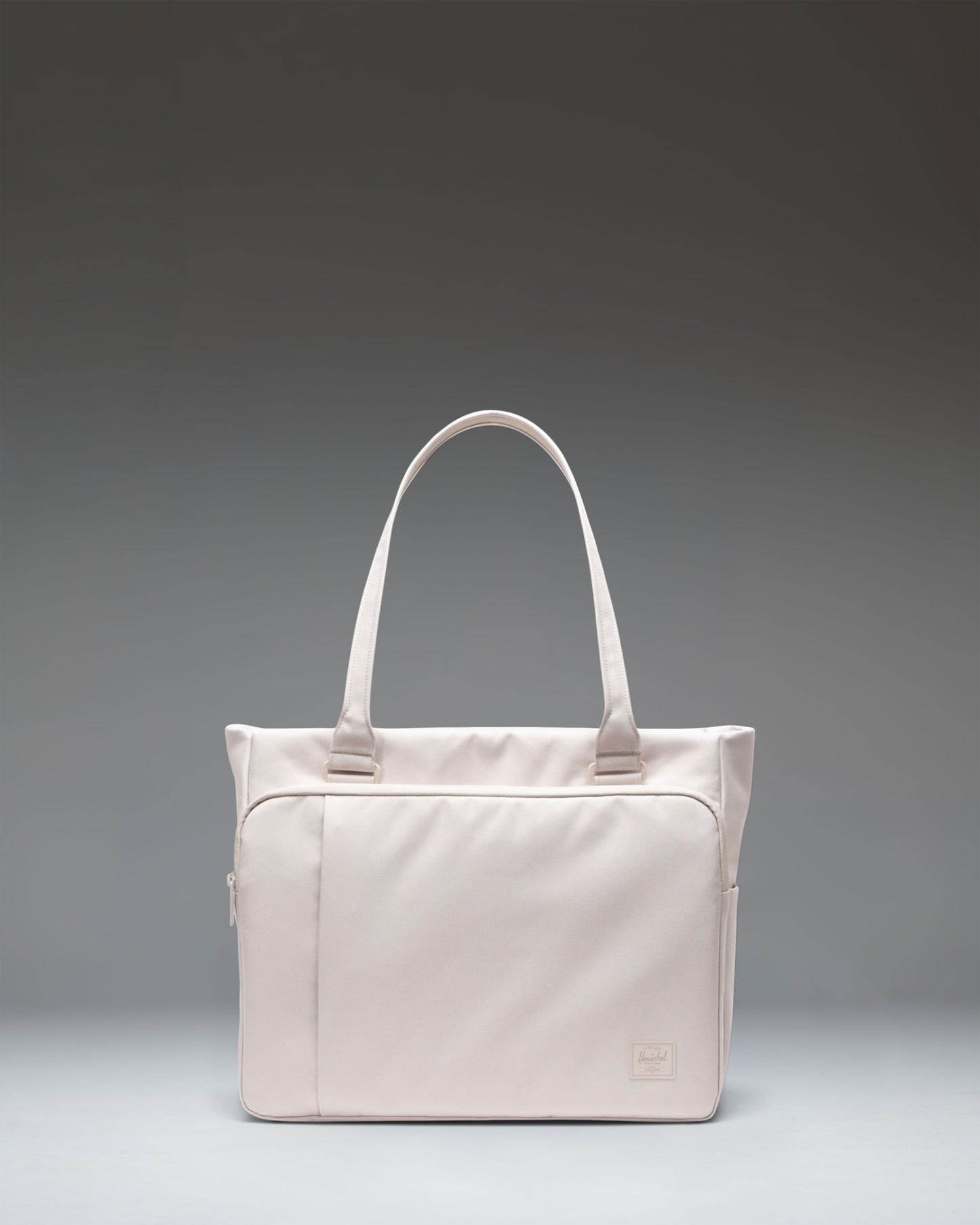 Herschel Kaslo Tote Tech in Moonbeam Tonal, a cream-white tote bag with black handles and zippered compartments.