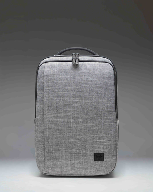 Front view of the Herschel Kaslo Travel Backpack Tech in Raven Crosshatch, featuring a textured grey design with multiple zippered compartments.