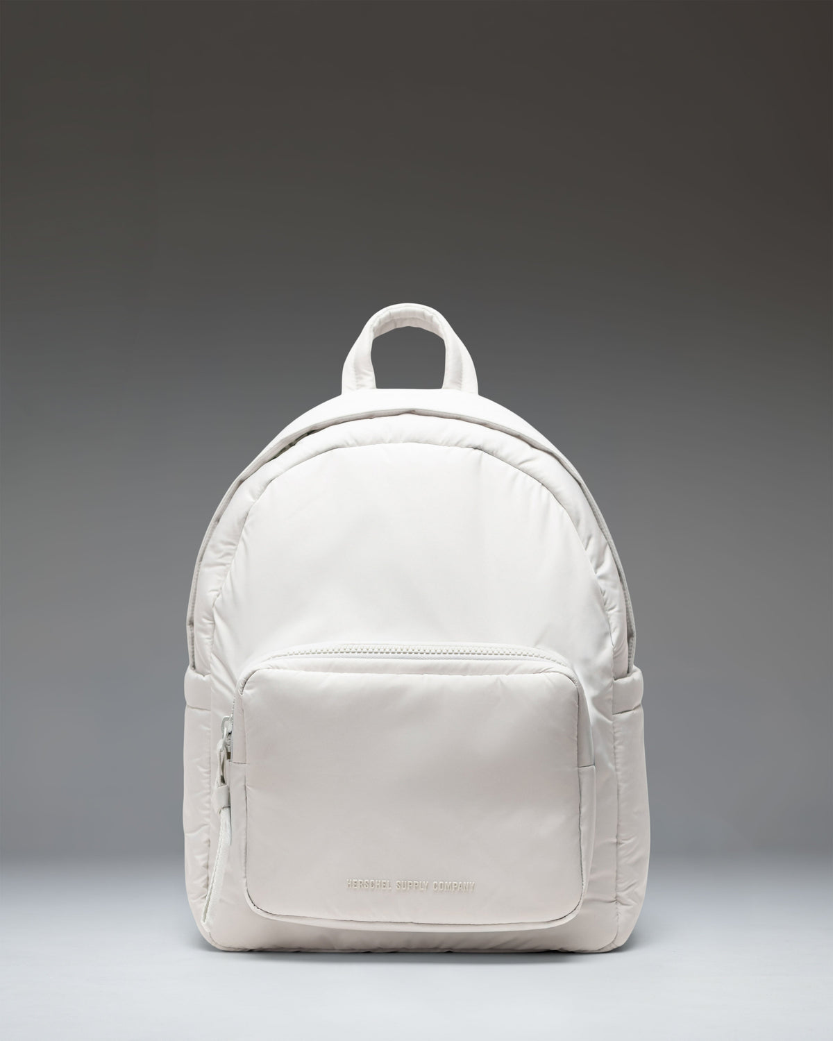 Herschel Supply Co. Cloudform Backpack in Metal color, showing the clean, minimalist design and front zipper pocket of the backpack.
