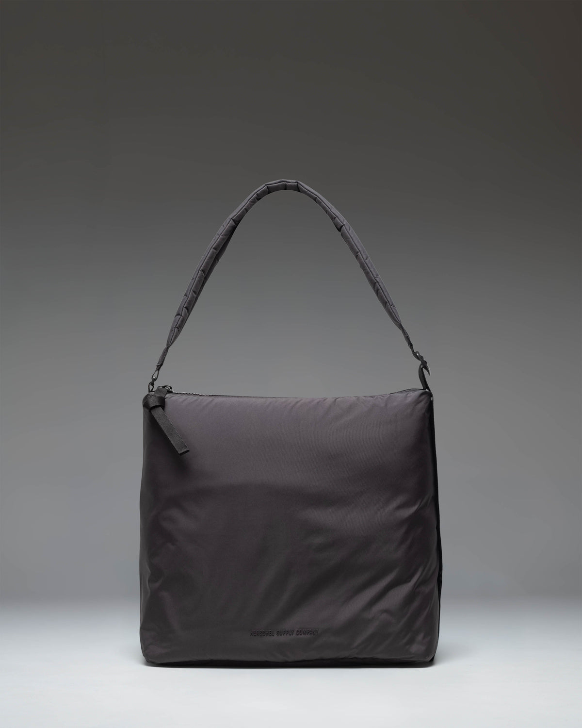 Herschel Supply Co Cloudform Tote in black, showcasing a clean, minimalist design with dual top handles and a spacious main compartment.