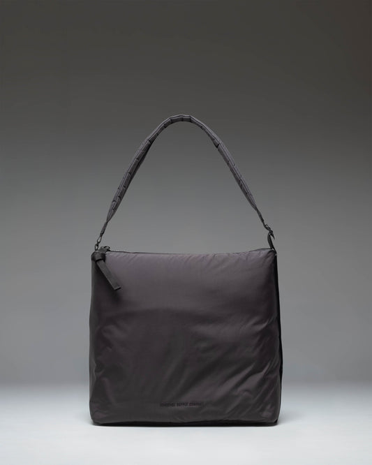 Herschel Supply Co Cloudform Tote in black, showcasing a clean, minimalist design with dual top handles and a spacious main compartment.