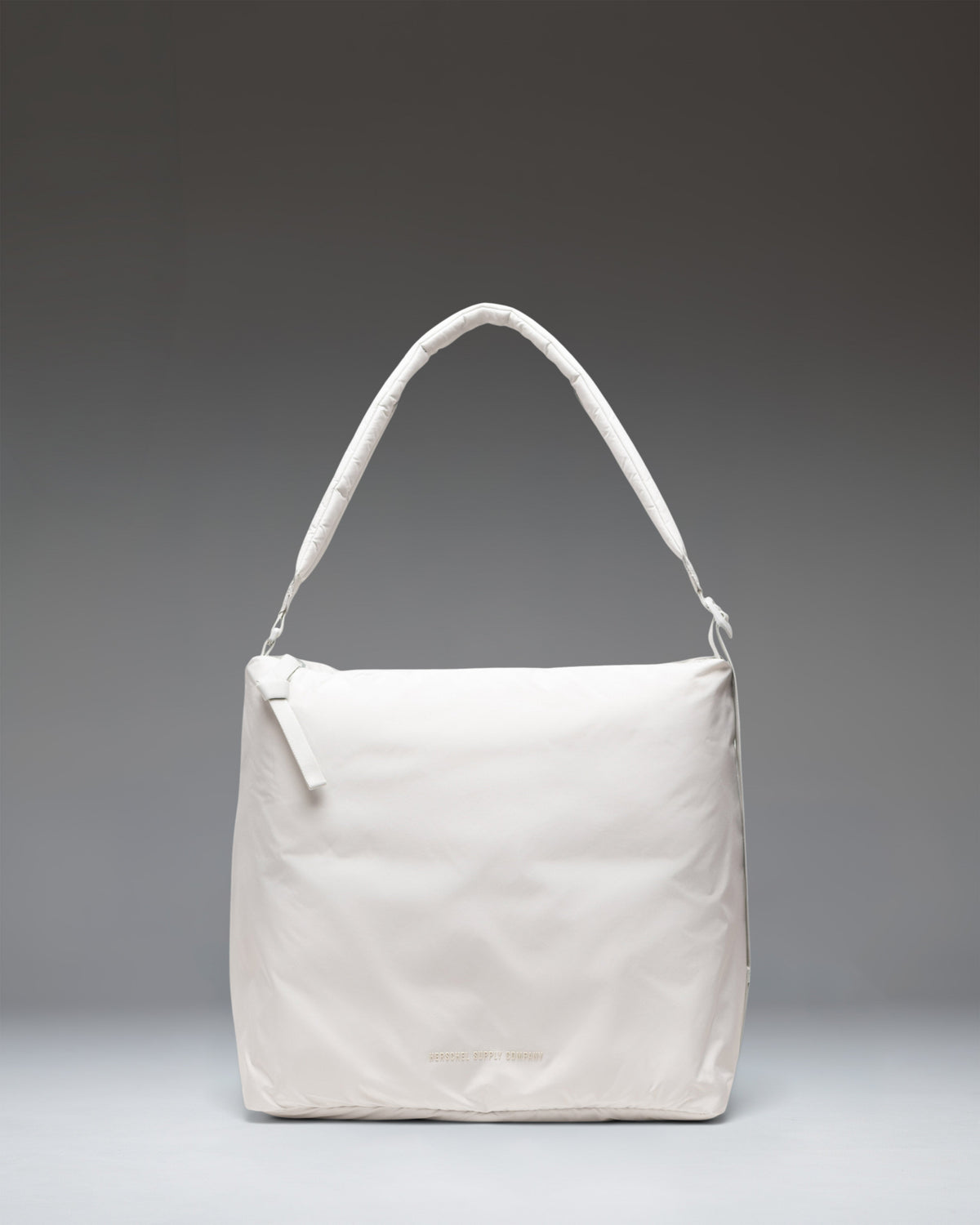 Herschel Supply Co. Cloudform Tote in Metal, a lightweight padded tote bag with a minimalist design, top handles, and adjustable shoulder strap.