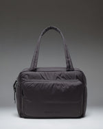 Herschel Supply Co. Cloudform Duffle bag in black, showing the clean, minimalist exterior design and durable carrying straps.