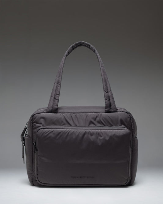 Herschel Supply Co. Cloudform Duffle bag in black, showing the clean, minimalist exterior design and durable carrying straps.