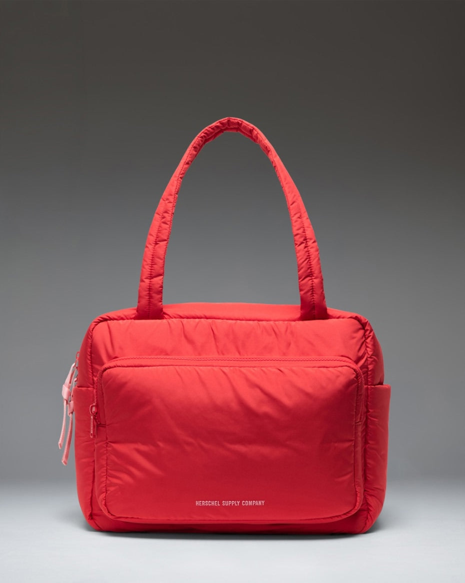 Herschel Supply Co. Cloudform Duffle in Salsa red, featuring a minimalist, padded quilted design with top handles and a front pocket.