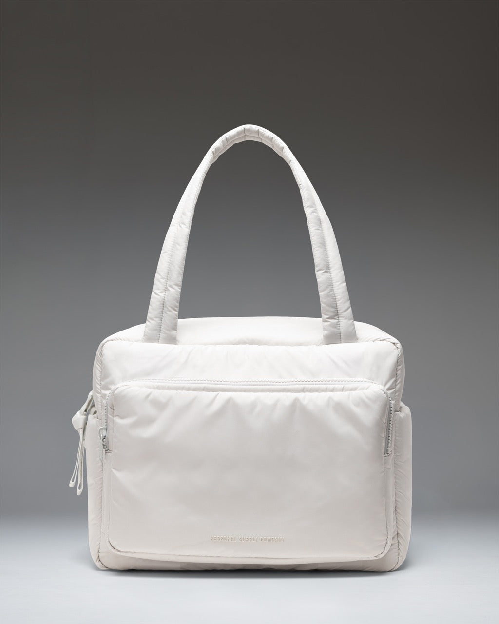 Herschel Supply Co. Cloudform Duffle Bag in Metal colorway. Lightweight, minimalist design with padded fabric, dual top handles, and logo detail.