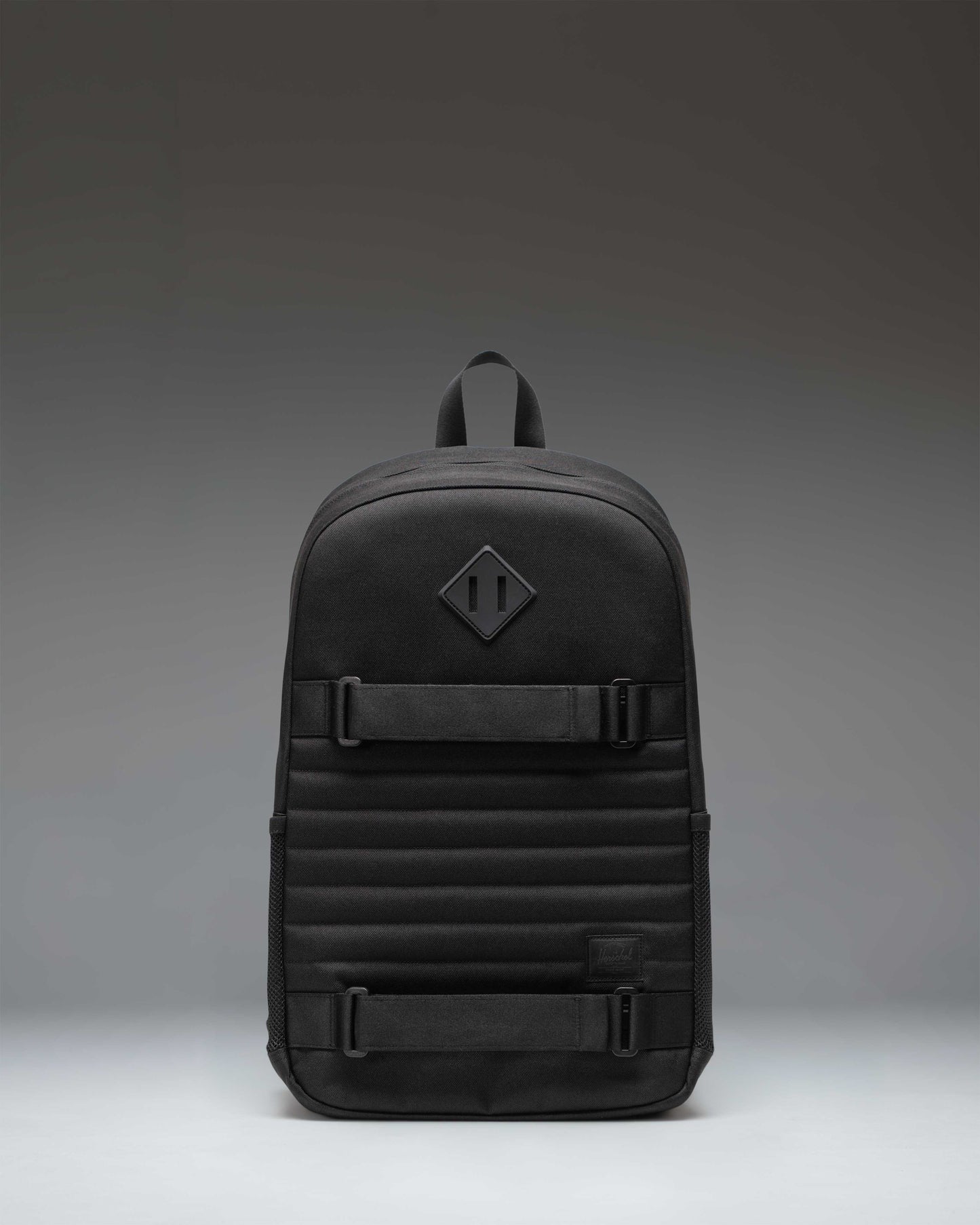 Herschel Supply Co. Fleet Skate Backpack in black, featuring an open front pocket with adjustable skate straps and a classic woven label.