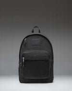 Herschel Supply Co. Kaine Backpack in black, featuring a front storage pocket, side water bottle pockets, and adjustable shoulder straps.