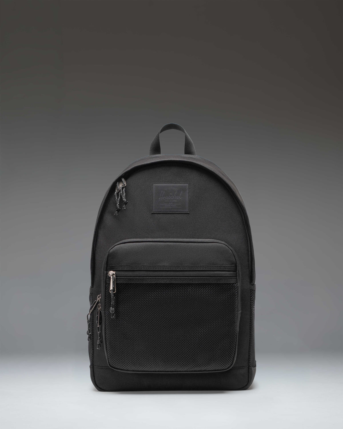 Herschel Supply Co. Kaine Backpack in black, featuring a front storage pocket, side water bottle pockets, and adjustable shoulder straps.