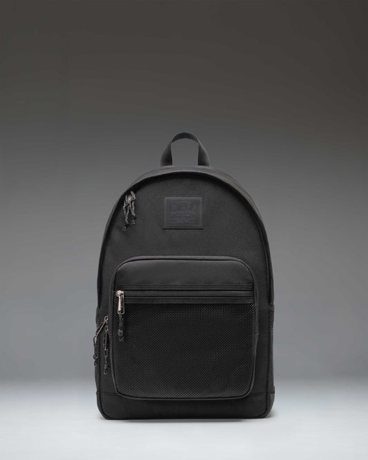 Herschel Supply Co. Kaine Backpack in black, featuring a front storage pocket, side water bottle pockets, and adjustable shoulder straps.