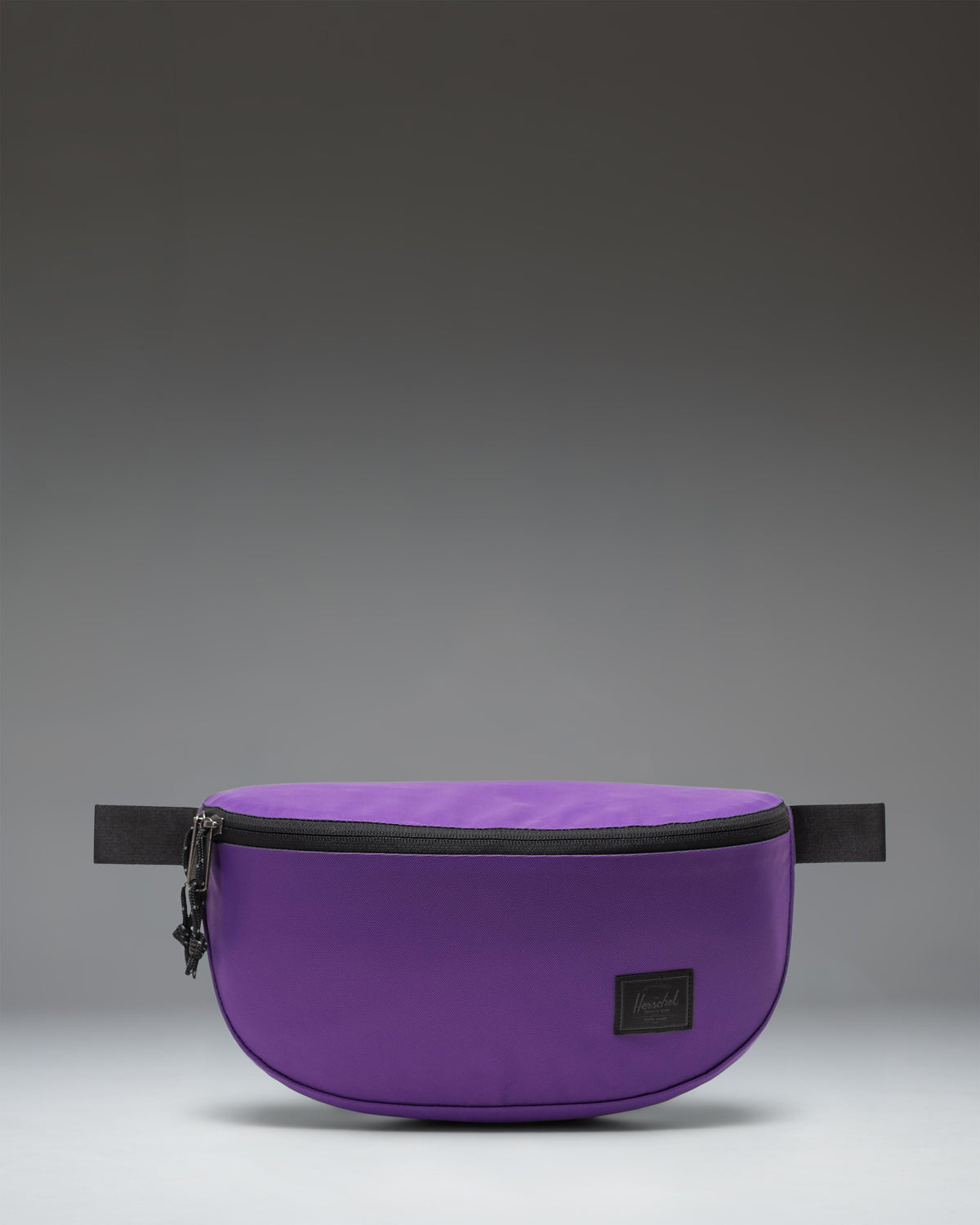 Herschel Supply Co. Kaine Hip Pack in Acai purple, featuring a zippered main compartment, front pocket, and adjustable strap with buckle.