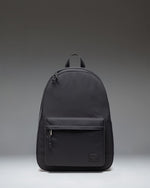 Front view of the Herschel Classic XL Backpack in black, featuring a zippered main compartment and front pocket with the signature woven label.