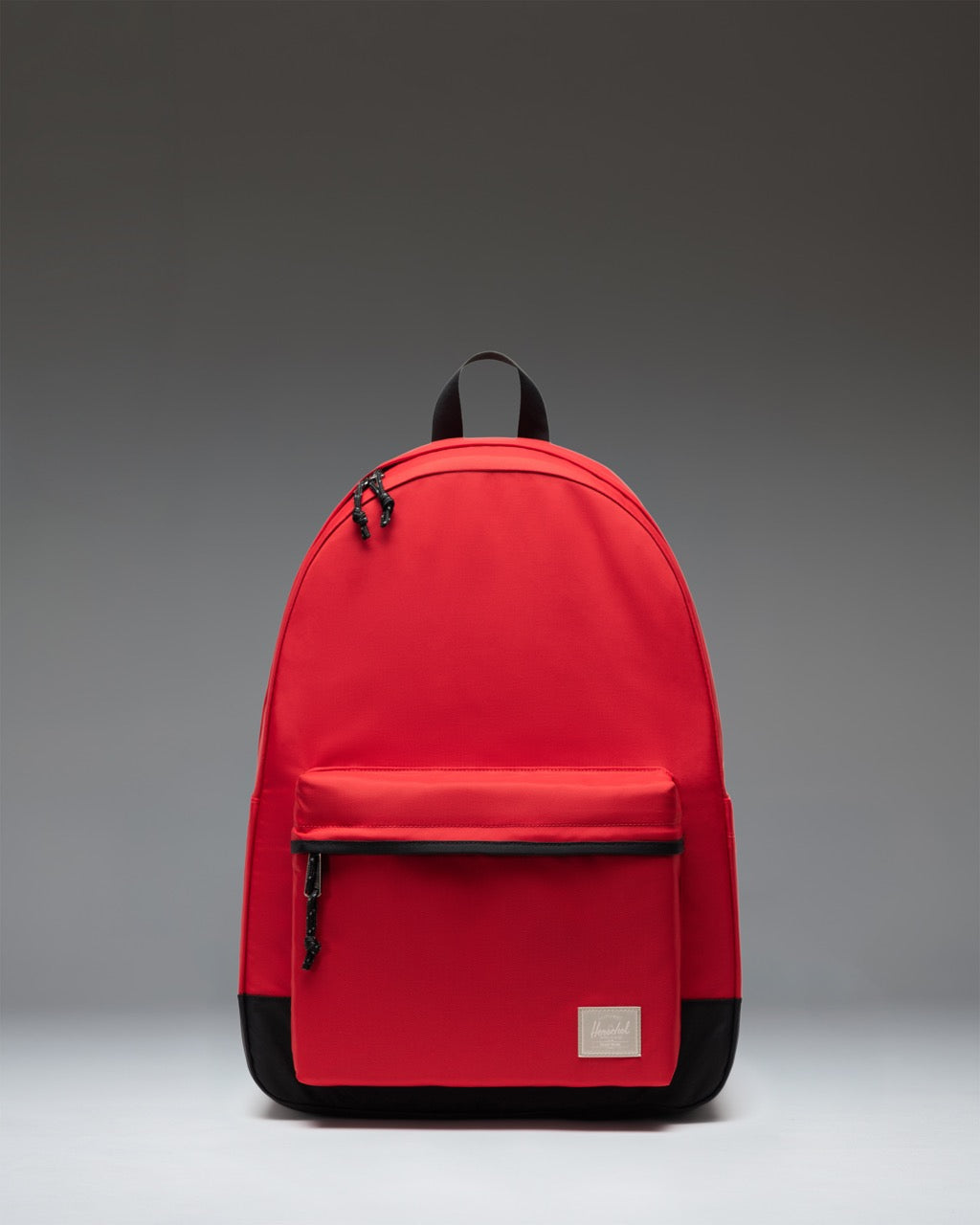 Herschel Supply Co. Classic XL Backpack in Barbados Cherry red, shown from the front highlighting the main compartment and front pocket.