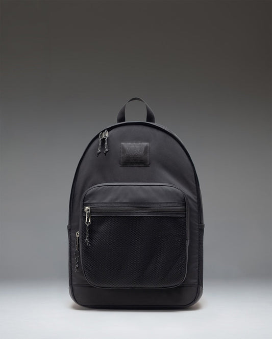 Herschel Supply Co. Kaine Backpack in black, showing the front view with zippered pockets and mesh side pockets.