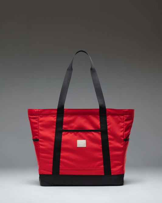 Herschel Heritage Tote bag in Barbados Cherry red and black, showing the spacious interior and a laptop compartment.