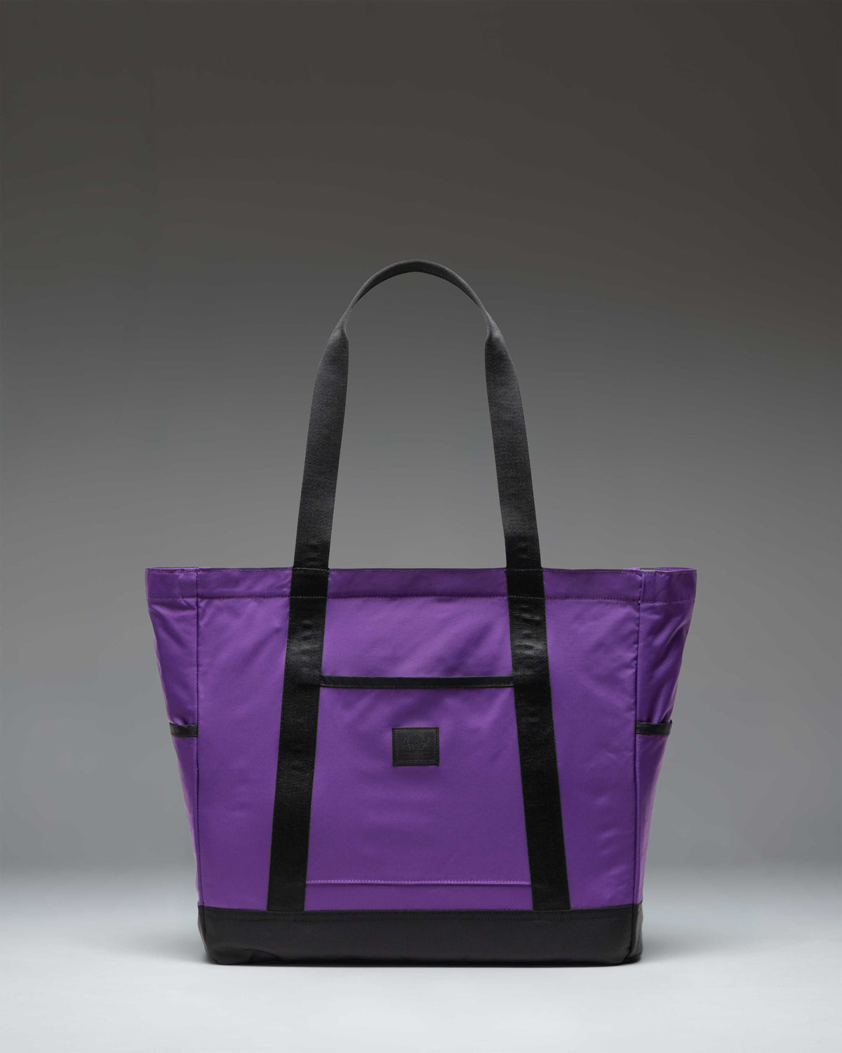 Herschel Heritage Tote bag in Acai purple with dual top handles and the classic Herschel woven logo label on the front.