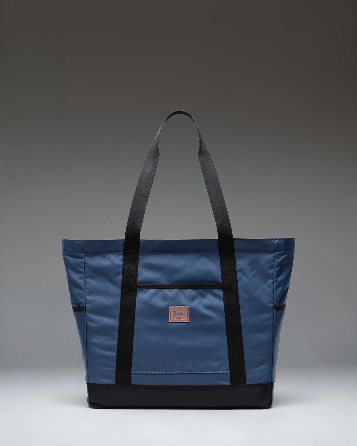 Herschel Heritage Tote bag in Oceana blue, featuring a classic design with dual carry handles and the signature Herschel woven label.