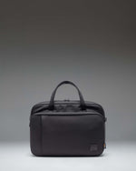 Black Herschel Supply Co. Gibson Messenger Tech Cordura bag showing the front view with handles and adjustable shoulder strap.