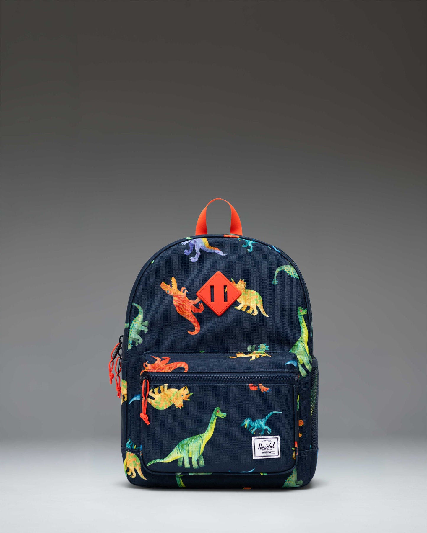Herschel Heritage Kids Backpack in Water Colour Dinosaurs Darkest Navy featuring colorful dinosaur illustrations on a dark navy background.