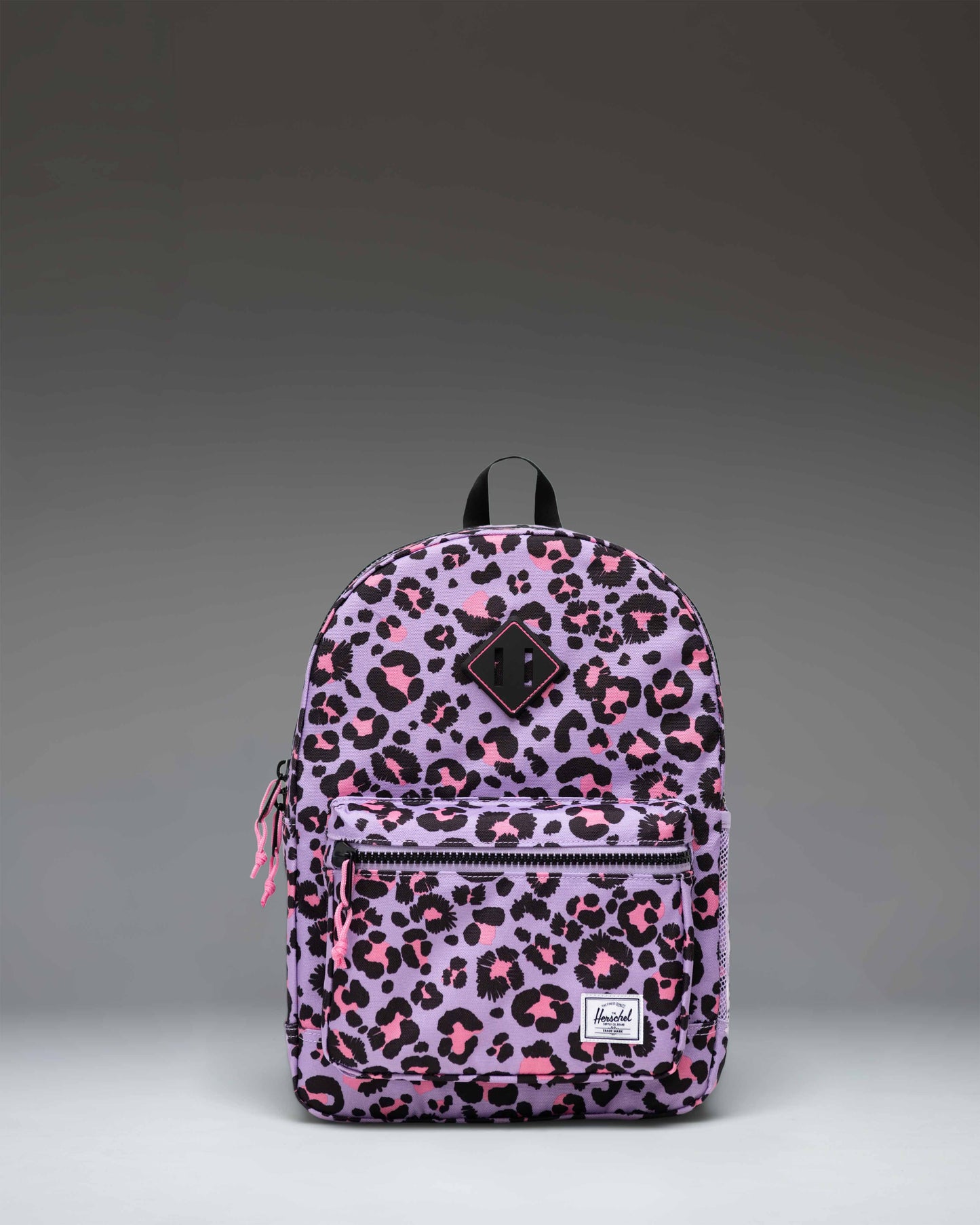 Herschel Heritage Kids Backpack in Scribble Leopard Sachet Pink pattern, featuring a pink leopard print with black and yellow scribble accents.