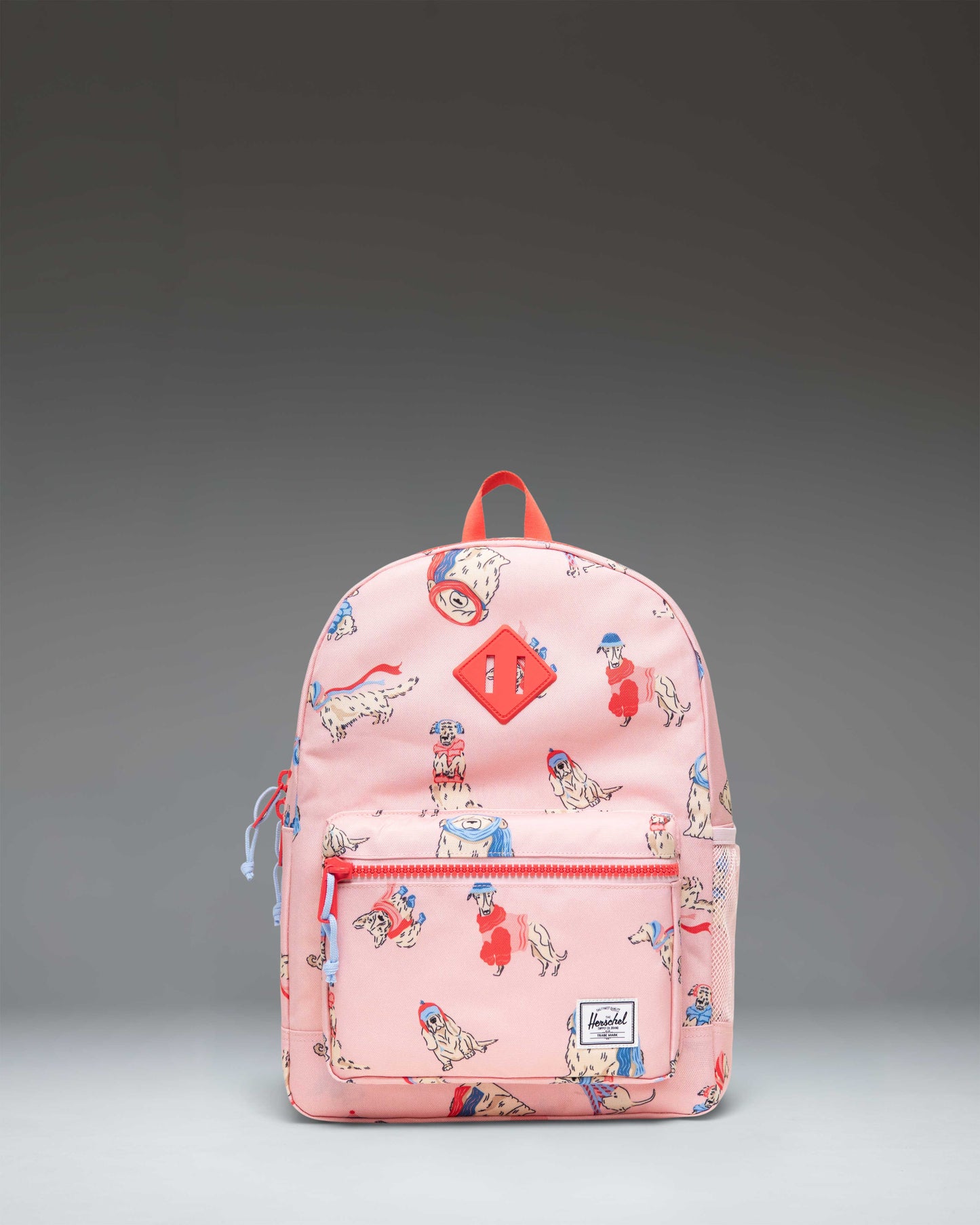 Herschel Heritage Kids Backpack in the Fashion Dogs colorway, featuring a playful print of various illustrated dogs.