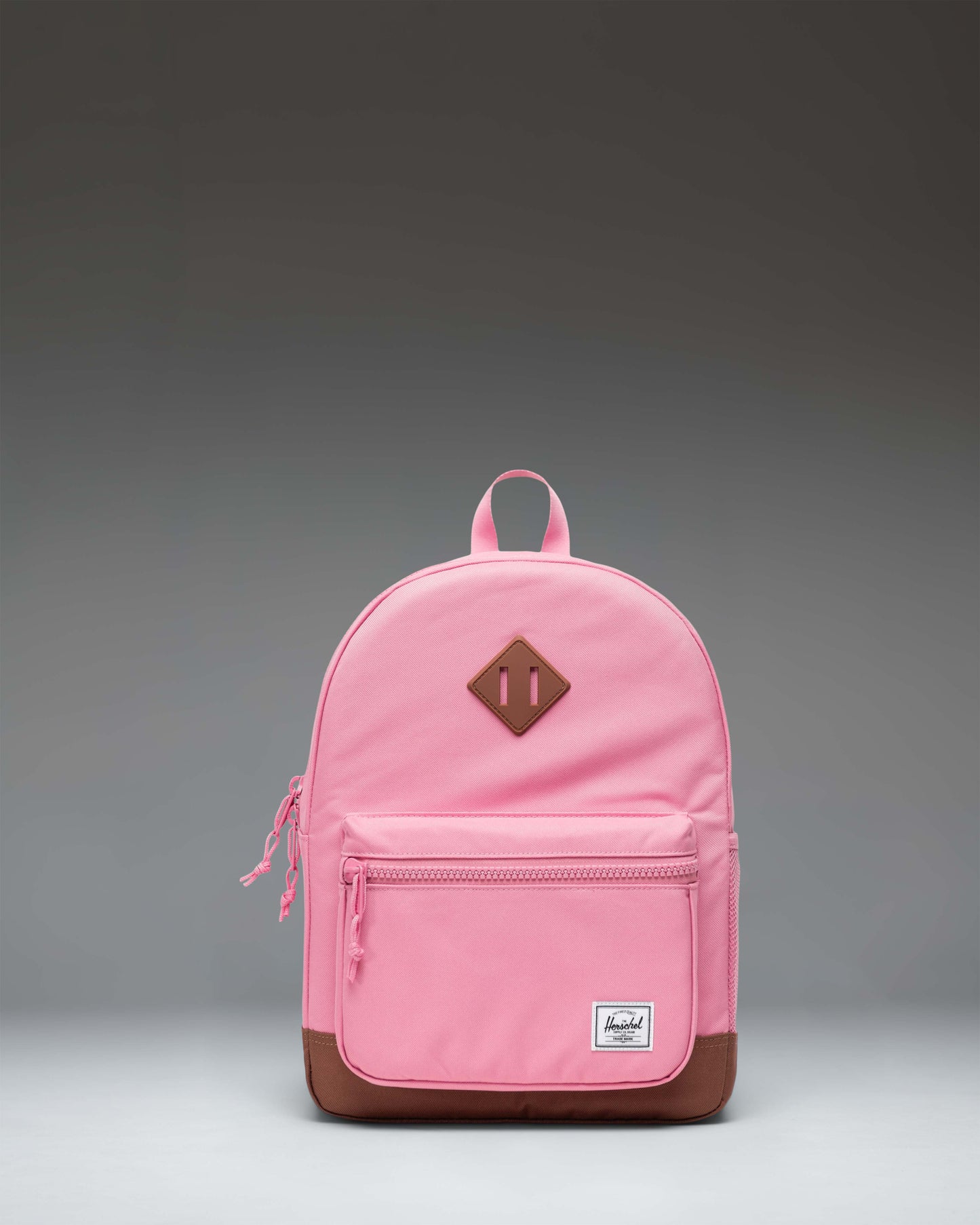 Herschel Heritage Kids Backpack in Cashmere Rose pink featuring a Saddle Brown diamond accent and front pocket details.