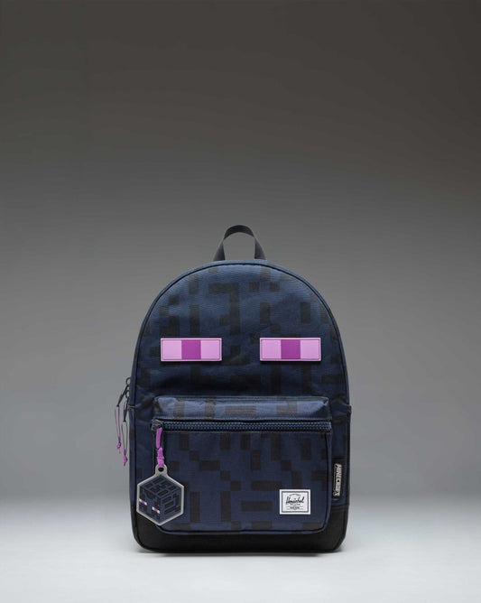 Minecraft Herschel Heritage Kids Backpack in Enderman black and purple print, featuring a pixelated character design and a front storage pocket.