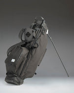Herschel Watt Light Stand Bag in Black, showcasing a sleek, lightweight golf stand bag with multiple pockets and a dual shoulder strap.