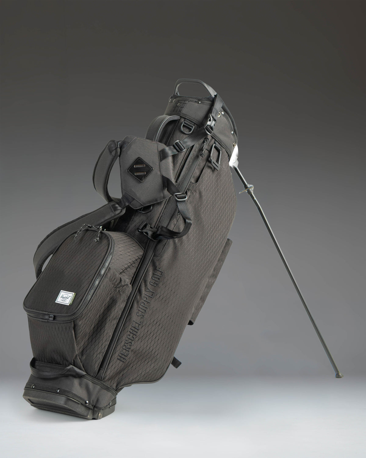 Herschel Watt Light Stand Bag in Black, showcasing a sleek, lightweight golf stand bag with multiple pockets and a dual shoulder strap.