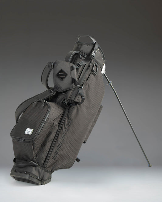Herschel Watt Light Stand Bag in Black, showcasing a sleek, lightweight golf stand bag with multiple pockets and a dual shoulder strap.