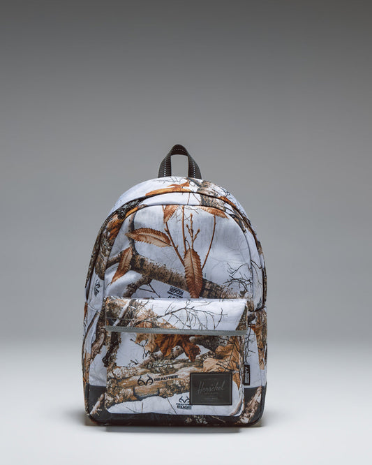 Herschel Classic Backpack in Realtree Edge Camo White/Black, showcasing the tree branch and leaf camouflage pattern.