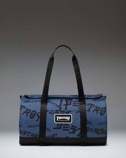 Herschel Heritage Skate Duffle Nylon in Oceana and Dark Navy Destroy, showing the durable design, skate straps, and Thrasher logo detailing.