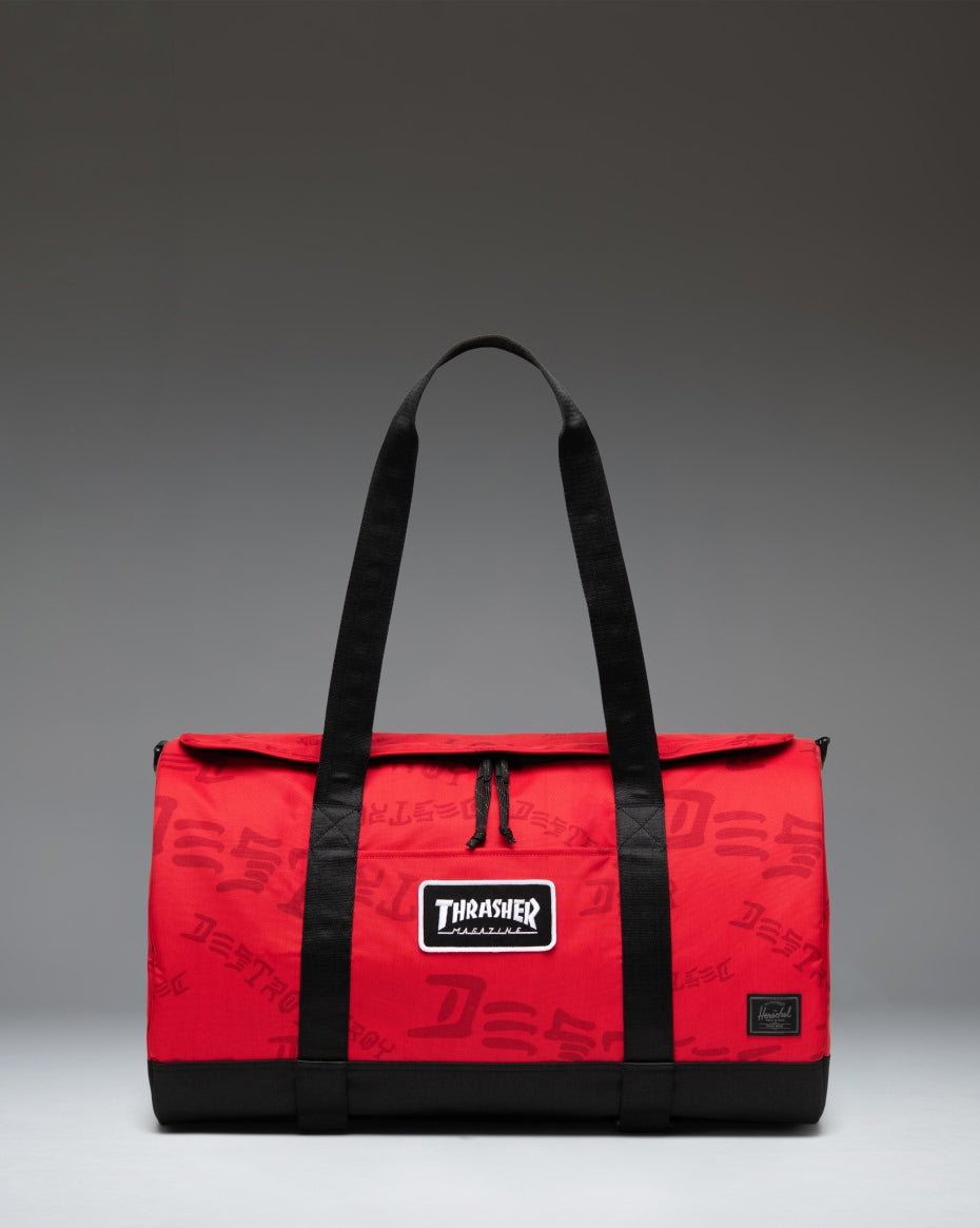 Herschel Heritage Skate Duffle Nylon bag in Racing Red and Barbados Cherry featuring Thrasher branding, skate straps, and dual top handles.