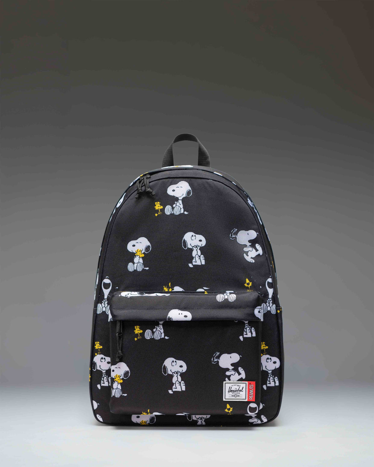 Herschel Supply Co. Peanuts Classic XL Backpack in Snoopy and Woodstock Black featuring a repeating pattern of the classic comic characters.