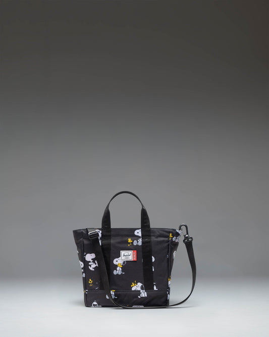Black Peanuts Herschel Heritage Small Tote bag featuring a Snoopy and Woodstock graphic print on the front pocket.