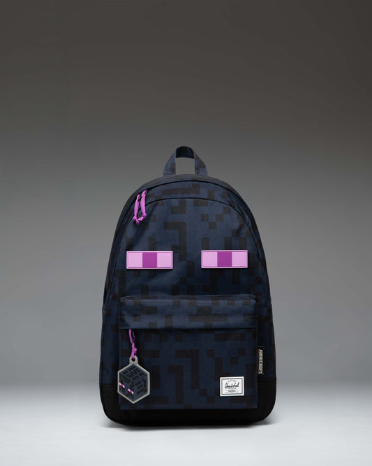 Herschel Supply Co. x Minecraft Enderman backpack featuring the iconic pixelated Enderman character eyes on a black background.