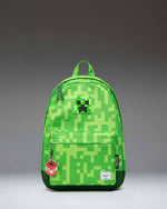 Herschel Supply Co. Minecraft Heritage youth backpack featuring the iconic pixelated green Creeper pattern.