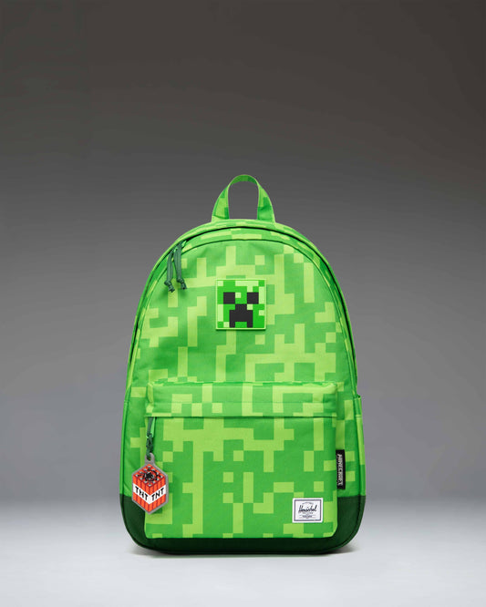 Herschel Supply Co. Minecraft Heritage youth backpack featuring the iconic pixelated green Creeper pattern.
