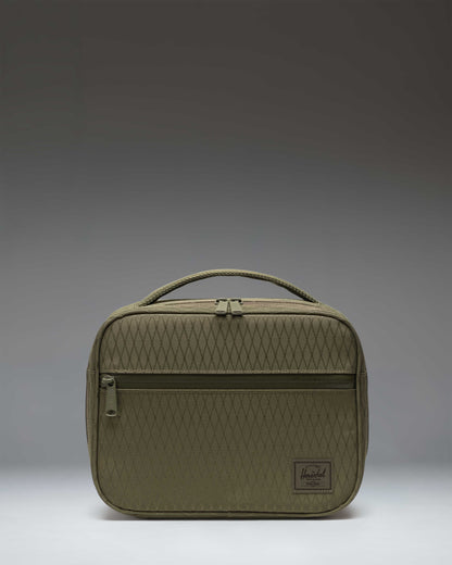 Herschel Supply Co. Pop Quiz Lunch Box in Ivy Green Diamond, featuring a durable geometric textured fabric, front pocket, and top handle.