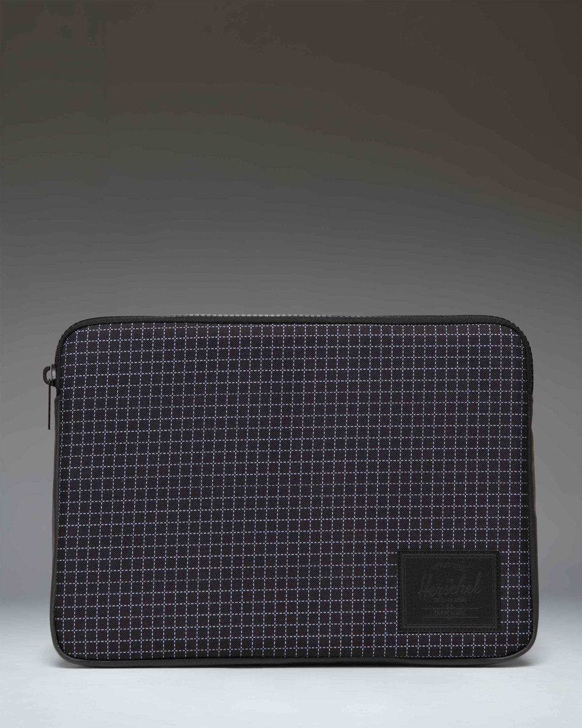 Herschel Supply Co. Anchor 14 Inch Sleeve in Grid Black/Black, a padded laptop sleeve with a grid pattern and classic logo label.