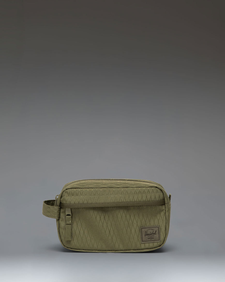 Herschel Supply Co. Chapter Small Travel Kit in Ivy Green Diamond featuring a textured diamond pattern with a convenient carrying handle.