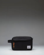 Herschel Supply Co. Chapter Travel Kit in black, showing the clean exterior design, side handle, and front zippered pocket.